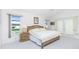 Bright main bedroom with neutral tones, ceiling fan, and backyard view at 910 Via Tripoli, Punta Gorda, FL 33950