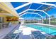 Screened pool area with sun loungers and a yellow pool room showcasing a seamless indoor-outdoor transition at 910 Via Tripoli, Punta Gorda, FL 33950