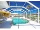 Sparkling screened-in pool with ample deck space and a beautiful backyard view at 910 Via Tripoli, Punta Gorda, FL 33950