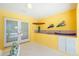 Bright yellow pool room showcasing a functional wet bar and seamless indoor-outdoor transition at 910 Via Tripoli, Punta Gorda, FL 33950