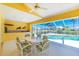 Enclosed porch with dining table overlooking a screened-in pool at 910 Via Tripoli, Punta Gorda, FL 33950