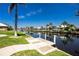 Waterfront view of the canal, including the private dock and backyard at 910 Via Tripoli, Punta Gorda, FL 33950