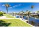 Waterfront view with a private boat lift and beautiful landscaping at 910 Via Tripoli, Punta Gorda, FL 33950