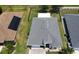 Aerial view of the house showing the roof, solar panels, well-manicured lawn, and surrounding neighborhood at 10068 Winding River Rd, Punta Gorda, FL 33950