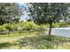 Backyard featuring a black metal fence and partial white privacy fence, providing secure outdoor space at 10068 Winding River Rd, Punta Gorda, FL 33950