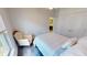 Neutral bedroom with comfy chair, ceiling fan and view to ensuite bath at 10068 Winding River Rd, Punta Gorda, FL 33950