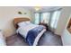 Comfortable bedroom with large windows, ceiling fan, and a wicker headboard at 10068 Winding River Rd, Punta Gorda, FL 33950