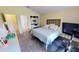 Bright bedroom featuring modern geometric headboard, ensuite bath, and stylish decor at 10068 Winding River Rd, Punta Gorda, FL 33950