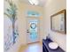 Bright foyer with tiled flooring, decorative glass door, stylish console table, and ample natural light at 10068 Winding River Rd, Punta Gorda, FL 33950