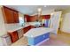 Elegant kitchen featuring wood cabinets, granite countertops, a center island, and stainless steel appliances at 10068 Winding River Rd, Punta Gorda, FL 33950