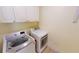 Convenient laundry room equipped with modern, front-load washer and dryer at 10068 Winding River Rd, Punta Gorda, FL 33950