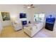 Inviting living room featuring neutral tones, a comfortable sofa, an aquarium, and large window at 10068 Winding River Rd, Punta Gorda, FL 33950