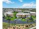 Aerial view of condo complex with lush landscaping, ample parking, and well-maintained buildings under a sunny sky at 1080 Bal Harbor Blvd # 11C, Punta Gorda, FL 33950
