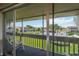 Screened balcony with a view of the lush green lawn and community pool at 1080 Bal Harbor Blvd # 11C, Punta Gorda, FL 33950