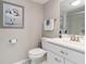 Bright bathroom featuring a white vanity, modern fixtures, and a framed art piece at 1080 Bal Harbor Blvd # 11C, Punta Gorda, FL 33950