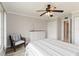 This bedroom features a ceiling fan, a comfortable seat, and a white dresser at 1080 Bal Harbor Blvd # 11C, Punta Gorda, FL 33950