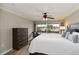 Bright bedroom featuring a sliding glass door, ceiling fan, and dark wood dresser at 1080 Bal Harbor Blvd # 11C, Punta Gorda, FL 33950