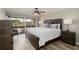 Comfortable bedroom featuring a plush bed, soft lighting, and sliding glass doors to a balcony at 1080 Bal Harbor Blvd # 11C, Punta Gorda, FL 33950