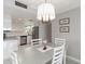 Stylish dining area with white table set, complemented by modern lighting and neutral decor at 1080 Bal Harbor Blvd # 11C, Punta Gorda, FL 33950