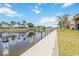 Exterior private dock with waterfront views, tropical trees, and condos at 1080 Bal Harbor Blvd # 11C, Punta Gorda, FL 33950