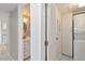 Hallway with a view into the bathroom and laundry room with white appliances at 1080 Bal Harbor Blvd # 11C, Punta Gorda, FL 33950