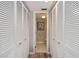 Hallway between multiple closets with a view into the bathroom with black and white patterned flooring at 1080 Bal Harbor Blvd # 11C, Punta Gorda, FL 33950