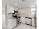 Contemporary kitchen with stainless steel appliances, granite countertops, and ample white cabinetry at 1080 Bal Harbor Blvd # 11C, Punta Gorda, FL 33950