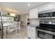Bright kitchen area flowing into the dining and living spaces, featuring modern appliances at 1080 Bal Harbor Blvd # 11C, Punta Gorda, FL 33950