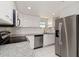 Well-equipped kitchen featuring stainless steel appliances, granite counters, and white cabinetry at 1080 Bal Harbor Blvd # 11C, Punta Gorda, FL 33950