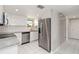 Modern kitchen with stainless steel appliances, granite countertops, and white cabinets at 1080 Bal Harbor Blvd # 11C, Punta Gorda, FL 33950