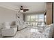 Comfortable living room with tile floors, plush seating, and balcony access, offering natural light and outdoor views at 1080 Bal Harbor Blvd # 11C, Punta Gorda, FL 33950