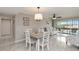 Inviting living room featuring a dining area, cozy seating, and a scenic balcony view at 1080 Bal Harbor Blvd # 11C, Punta Gorda, FL 33950