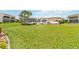 Exterior community pool with green spaces and lounging area at 1080 Bal Harbor Blvd # 11C, Punta Gorda, FL 33950