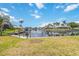 Waterfront view with private boat dock and lush tropical landscaping at 1080 Bal Harbor Blvd # 11C, Punta Gorda, FL 33950
