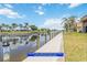 Waterfront view showcasing private boat docks available near the condo, surrounded by palm trees and serene water at 1080 Bal Harbor Blvd # 11C, Punta Gorda, FL 33950