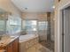 Bathroom featuring soaking tub, walk-in shower, and granite countertops at 11982 Granite Woods Loop, Venice, FL 34292
