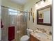 Well-appointed bathroom with a glass shower enclosure and granite countertop vanity at 11982 Granite Woods Loop, Venice, FL 34292