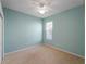 Small bedroom with light blue walls and a ceiling fan at 11982 Granite Woods Loop, Venice, FL 34292