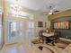 Elegant dining space with a large table, chandelier, and natural lighting at 11982 Granite Woods Loop, Venice, FL 34292