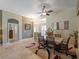 Inviting dining room with travertine floors, stylish furnishings, and natural light at 11982 Granite Woods Loop, Venice, FL 34292