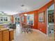 Bright dining room featuring tile floors, vibrant walls, and views of the outdoor pool at 11982 Granite Woods Loop, Venice, FL 34292