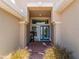 Inviting entryway featuring brick flooring, blue door, and ample natural light at 11982 Granite Woods Loop, Venice, FL 34292
