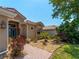 Landscaped front yard leading to the home with brick walkway and accents at 11982 Granite Woods Loop, Venice, FL 34292