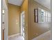 Bright hallway featuring tile flooring and access to the outdoor patio through a white door at 11982 Granite Woods Loop, Venice, FL 34292