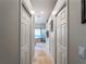 Hallway with linen closet leading to the bathroom and bedroom at 11982 Granite Woods Loop, Venice, FL 34292