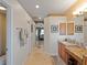 Hallway with linen closet leading to the bedroom and bathroom at 11982 Granite Woods Loop, Venice, FL 34292