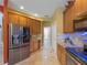 Modern kitchen featuring stainless steel appliances, custom cabinets, and granite countertops at 11982 Granite Woods Loop, Venice, FL 34292
