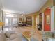 Bright living room with tan tiled floors, elegant decor and a dining area with seating for six at 11982 Granite Woods Loop, Venice, FL 34292