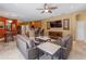 Inviting living room with comfortable seating, media center, and seamless access to the kitchen and dining areas at 11982 Granite Woods Loop, Venice, FL 34292