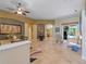 Open-concept living area with tile flooring, elegant furnishings, and pool view at 11982 Granite Woods Loop, Venice, FL 34292